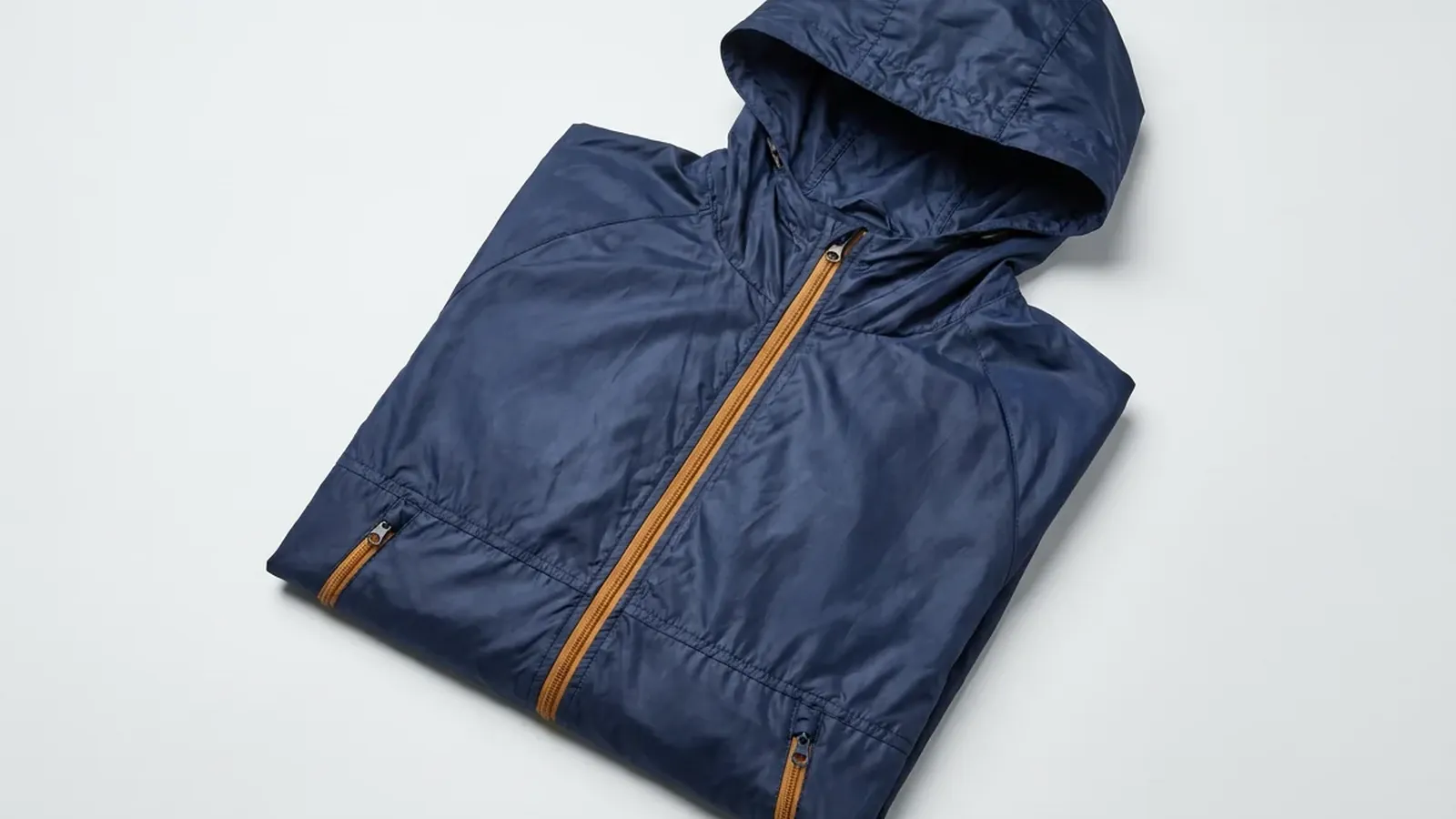 Undecorated fishing jacket, folded, no logo, no print, no woven label, neutral background